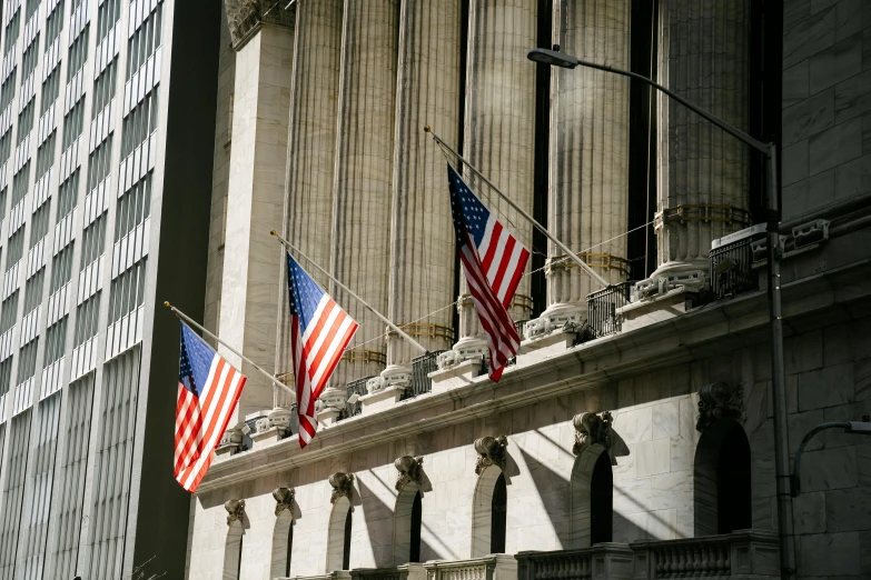 a group of american flags hanging from the side of a building, unsplash, renaissance, displaying stock charts, 2000s photo, canopies, 2 5 6 x 2 5 6 pixels