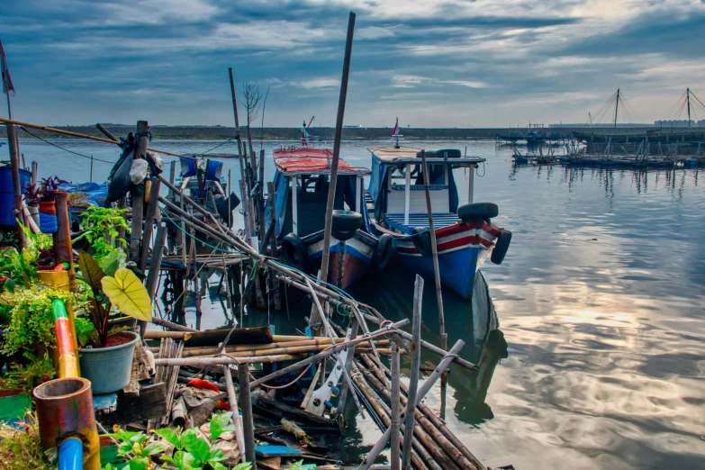 a number of boats in a body of water, by Jan Tengnagel, pexels contest winner, sumatraism, vines hanging over the water, avatar image, wood pier and houses, belongings strewn about