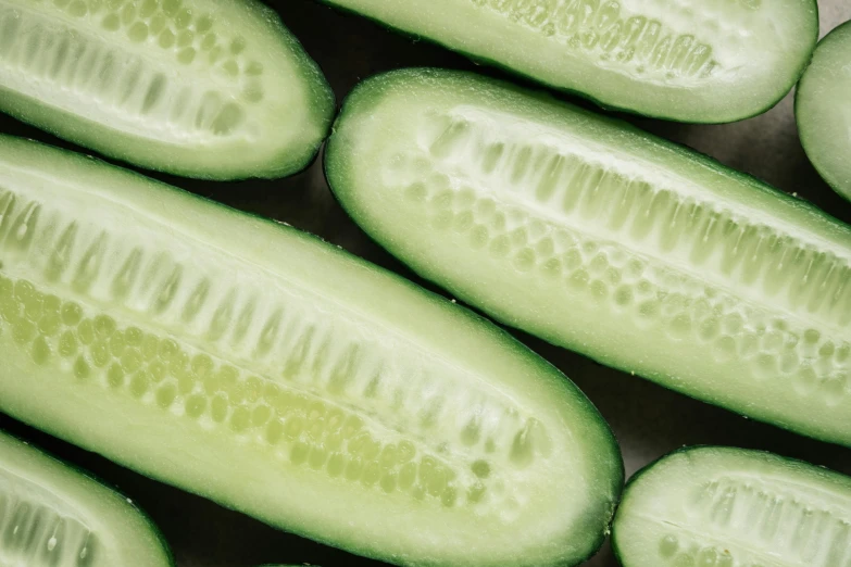 a close up of a bunch of sliced cucumbers, trending on pexels, flawless epidermis, an olive skinned, silver, panels