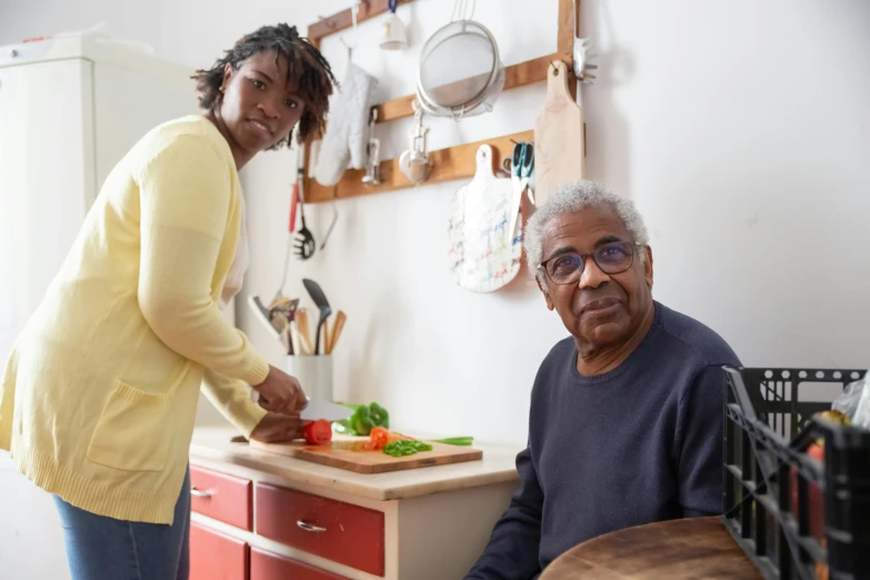 a woman standing next to a man in a kitchen, by Everett Warner, pexels contest winner, dementia, aida muluneh, on a wooden tray, alexis franklin