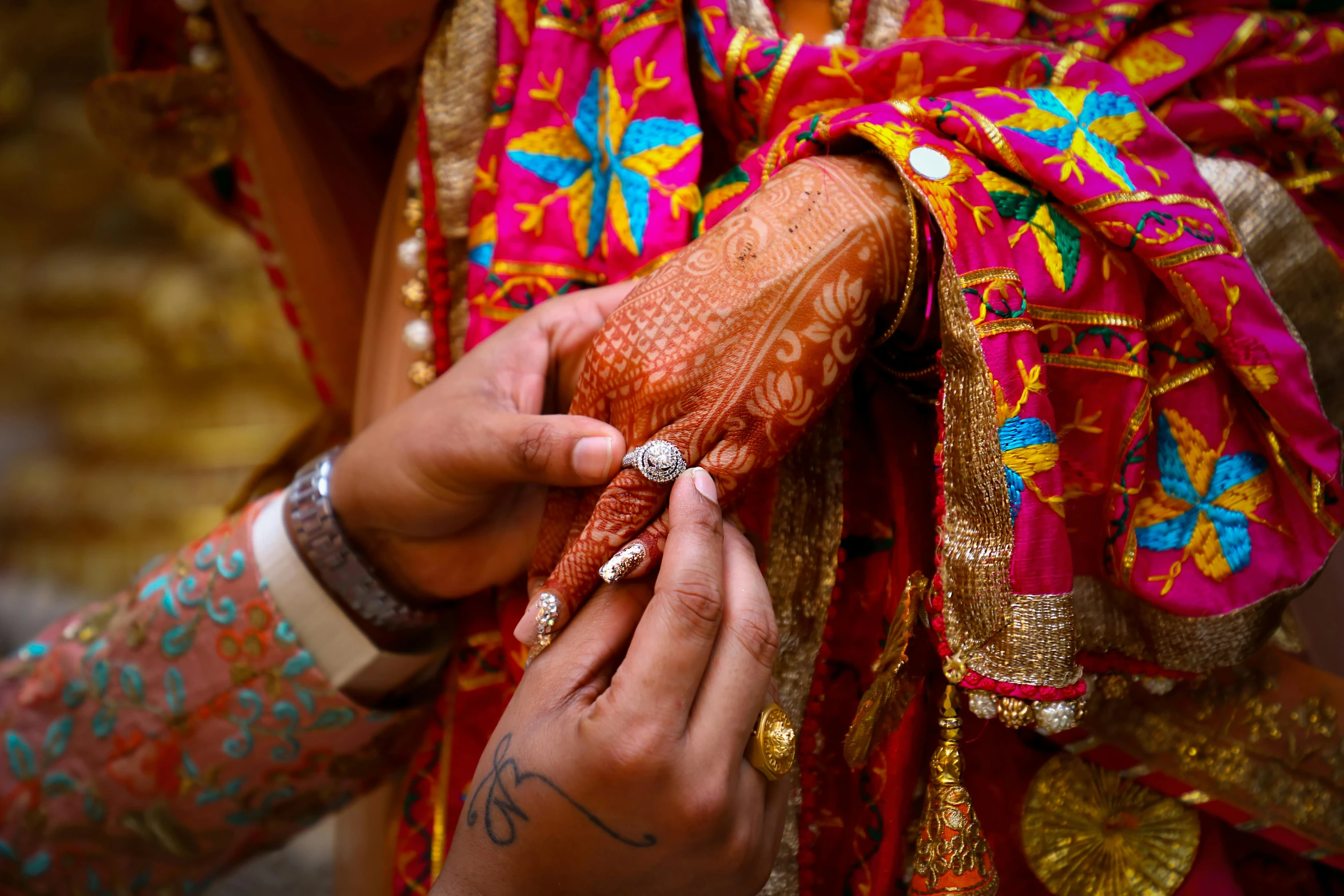 a woman putting a ring on another woman's hand, a picture, pexels, process art, indian patterns, colourful clothing, thumbnail, professional wedding photography