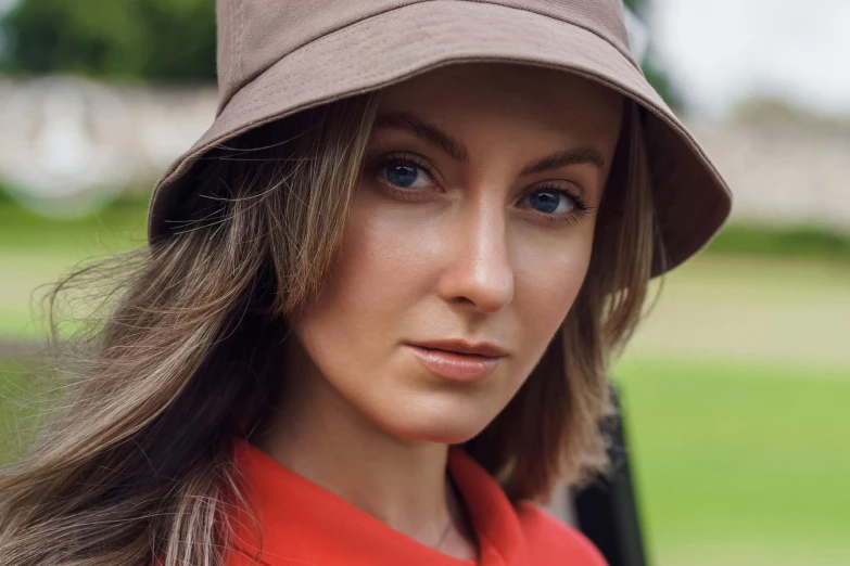 a close up of a person wearing a hat, she is wearing a hat