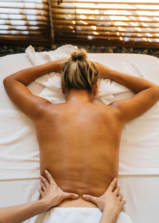 a woman getting a back massage at a spa, a portrait, trending on unsplash, renaissance, thumbnail, full frame image, back view »