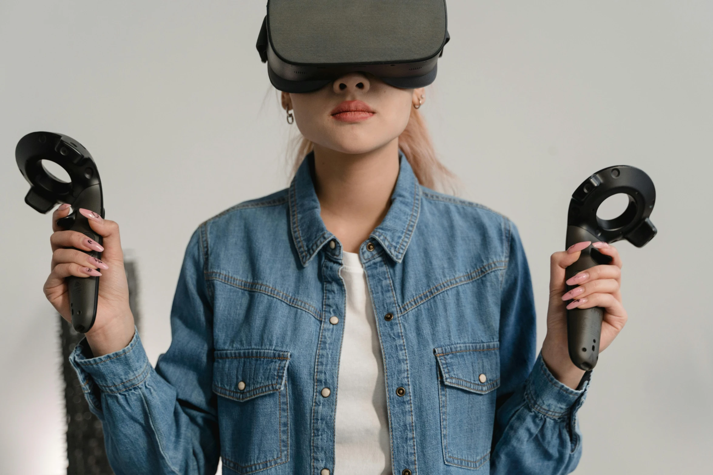 a woman in a denim shirt holding a pair of scissors, a hologram, trending on pexels, hypermodernism, wearing vr goggles, avatar image, wearing jeans and a black hoodie, asian female