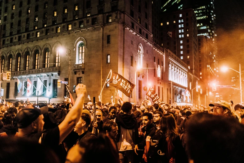 a group of people that are standing in the street, at night time, crowds, montreal, antifa