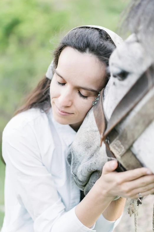 a close up of a person petting a horse, by Anna Haifisch, ana de la reguera portrait, arm around her neck, white and grey, lush surroundings