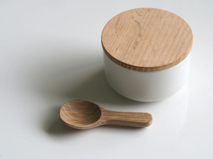 a white container with a wooden spoon next to it, unsplash, oak, mini model, pochi iida, white finish