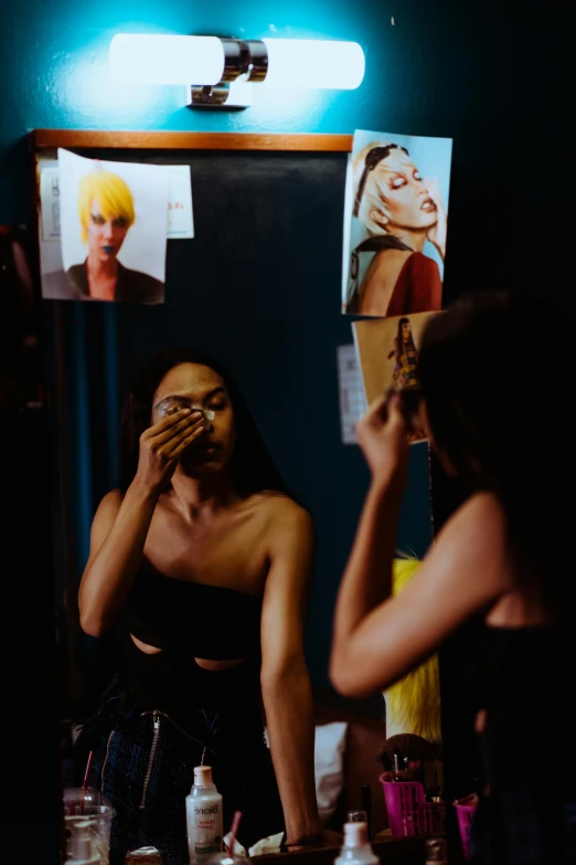 a woman that is standing in front of a mirror, inspired by Nan Goldin, trending on pexels, pat mcgrath, behind the scenes photo, two models in the frame, photo booth
