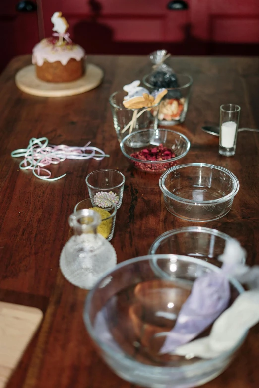 a wooden table topped with bowls of food, process art, glass labware, formulas, crystal encrustations, item