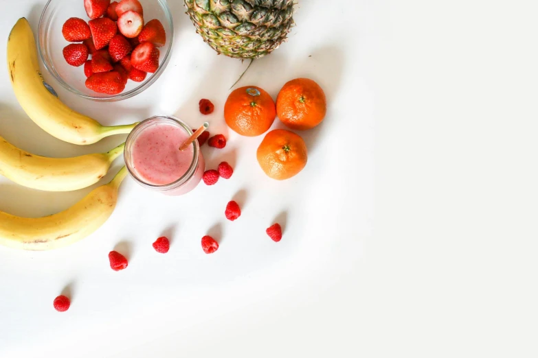 a white table topped with fruit and a pineapple, pexels, pink and red color scheme, background image, blender, having a snack