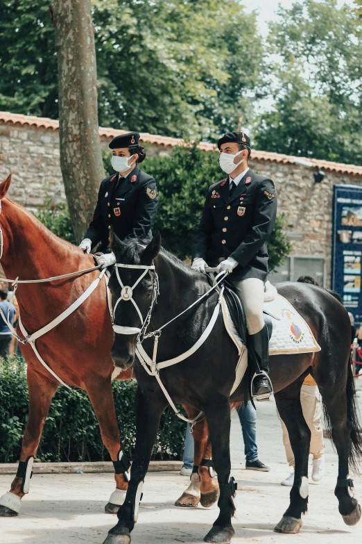 a couple of men riding on the backs of horses, wearing a mask, in uniform, giorgia meloni, university