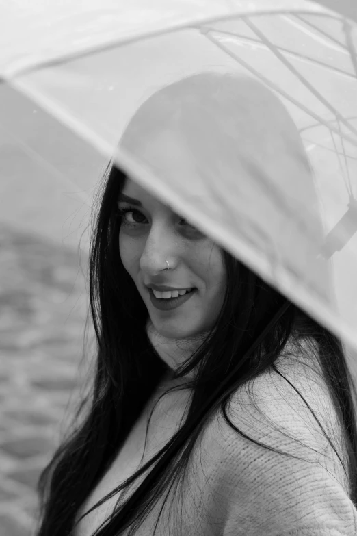 a black and white photo of a woman holding an umbrella, young woman with long dark hair, !subtle smiling!, on a boat, headshot profile picture