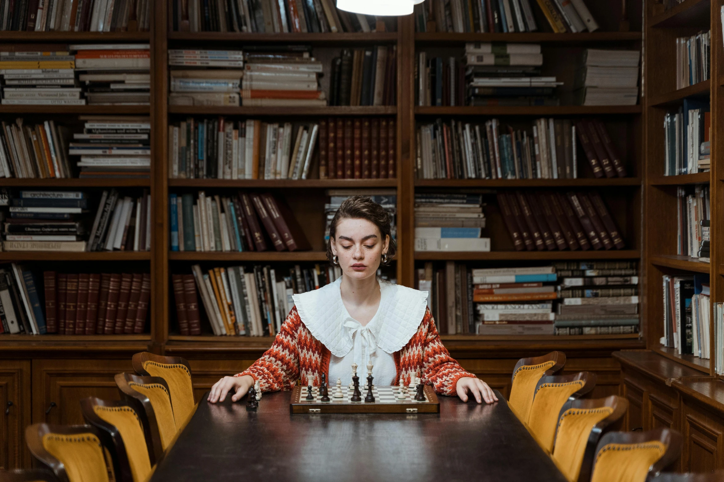 a woman playing a game of chess in a library, a portrait, by Emma Andijewska, unsplash, mannerism, erwin olaf, maisie williams, board games on a table, cinematic outfit photo