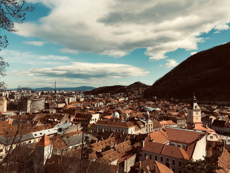 a view of a town from the top of a hill, by Emma Andijewska, pexels contest winner, baroque, square, with mountains as background, 💋 💄 👠 👗, bosnian