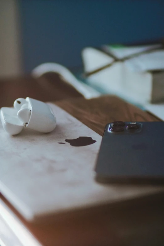 an apple airpods sitting on top of a wooden table, a still life, by Sven Erixson, trending on pexels, coffee stain, scanning items with smartphone, sink, heartbroken