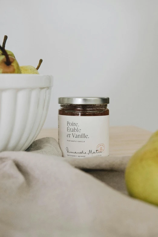 a bowl of pear jam next to a bowl of pears, by Nicolette Macnamara, private press, on a marble pedestal, product label, brunette, breakfast