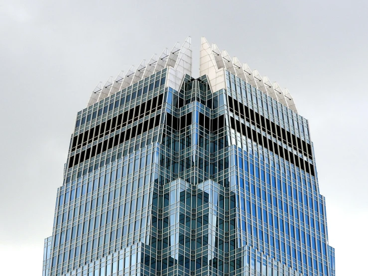 a very tall building with a lot of windows, capital plaza, glass reflections on top, taken in the late 2010s, tyndall rays