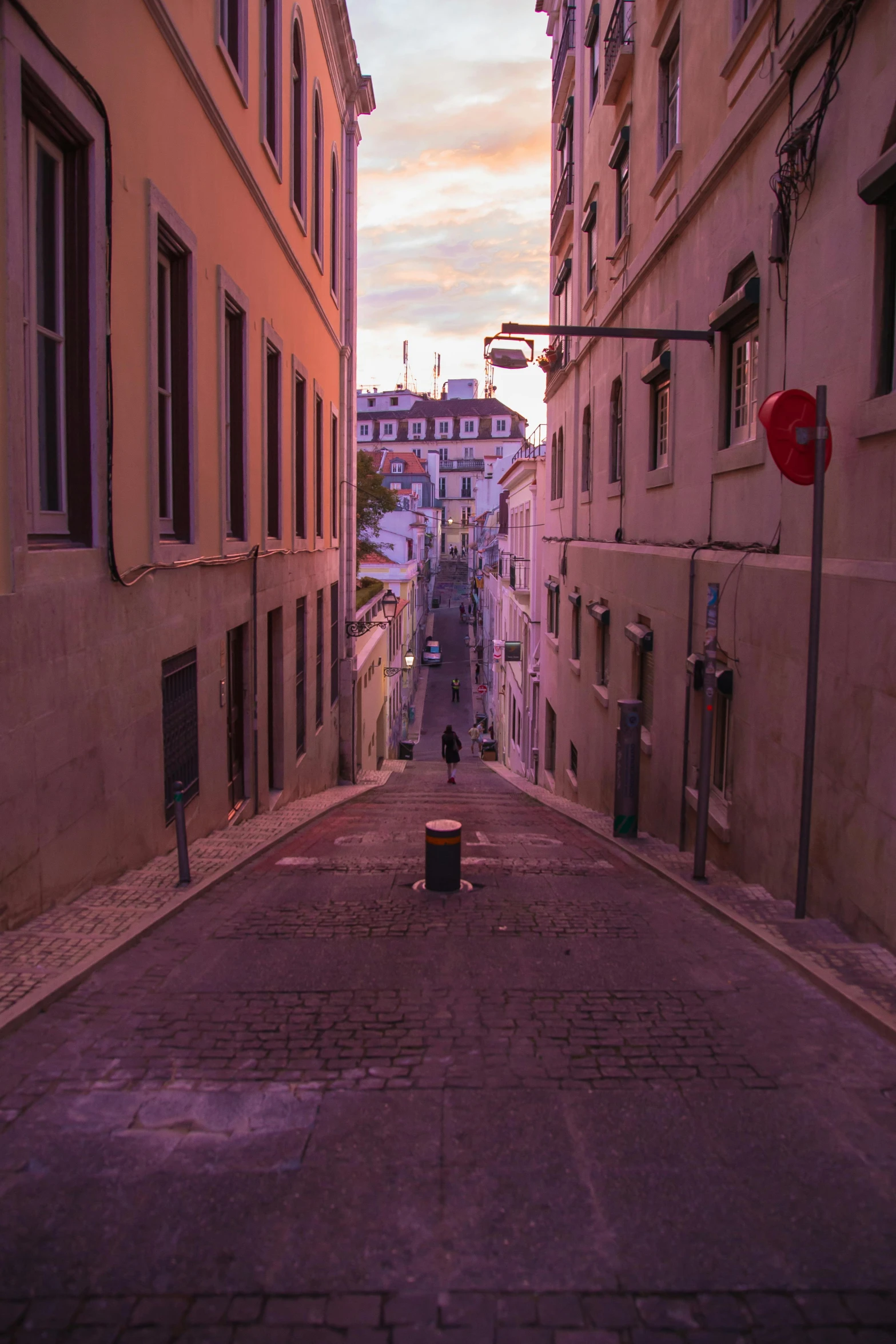 a narrow street in an old european city, by Emanuel Witz, pexels contest winner, lisbon, calm evening, hillside, pov photo