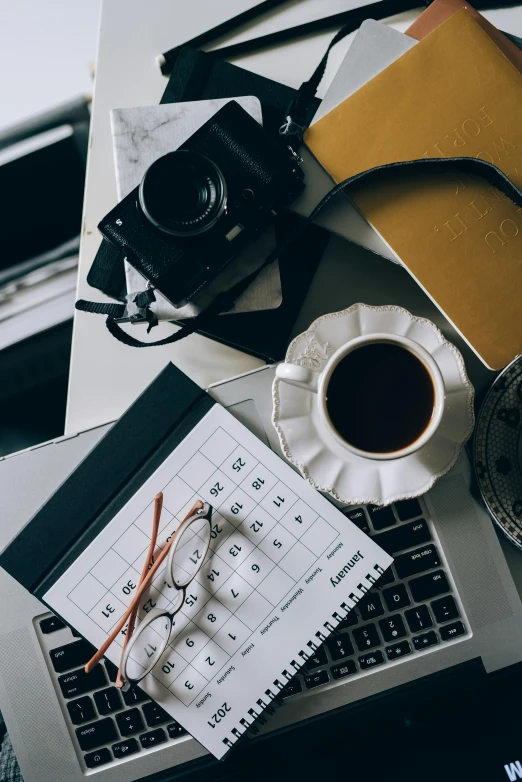 a laptop computer sitting on top of a desk next to a cup of coffee, unsplash contest winner, knolling, planning, ilustration, shot with sony alpha