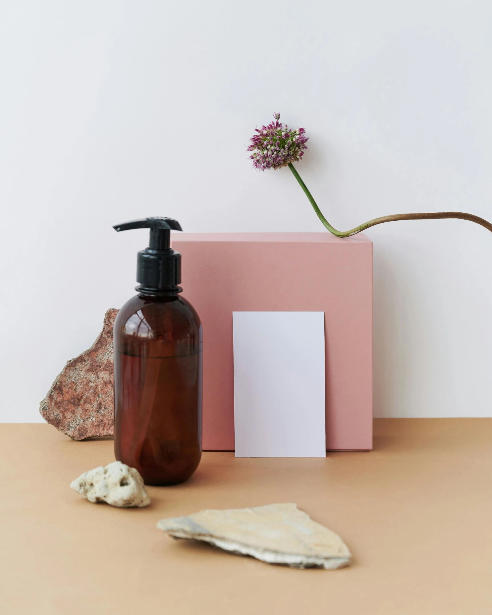 a bottle of liquid sitting on top of a table, by Helen Stevenson, minimalism, soap, greeting hand on head, high quality product image”, brown resin