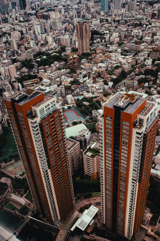 an aerial view of a city with tall buildings, pexels contest winner, hyperrealism, red building, arasaka, city apartment, color photo