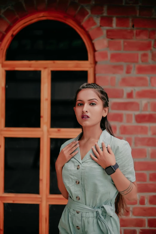 a woman standing in front of a brick building, by Max Dauthendey, trending on pexels, beautiful young himalayan woman, indoor picture, background image, pout