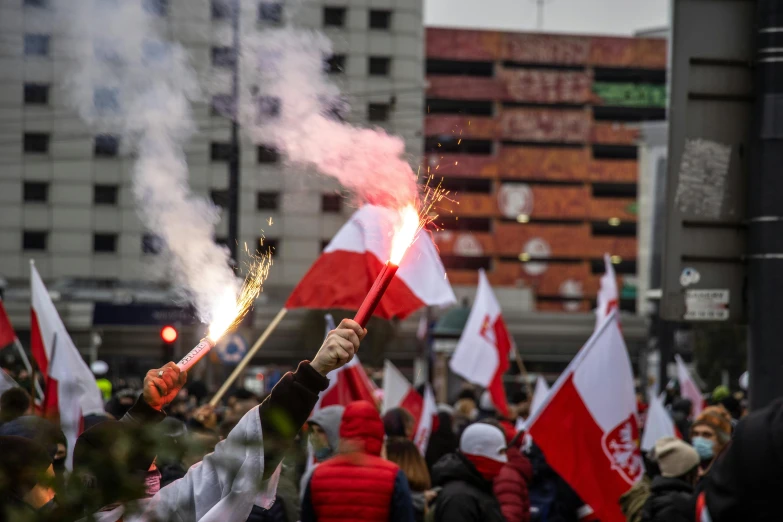 a crowd of people holding canadian flags and sparklers, by Julia Pishtar, happening, poland flag, buenos aires, 🚿🗝📝