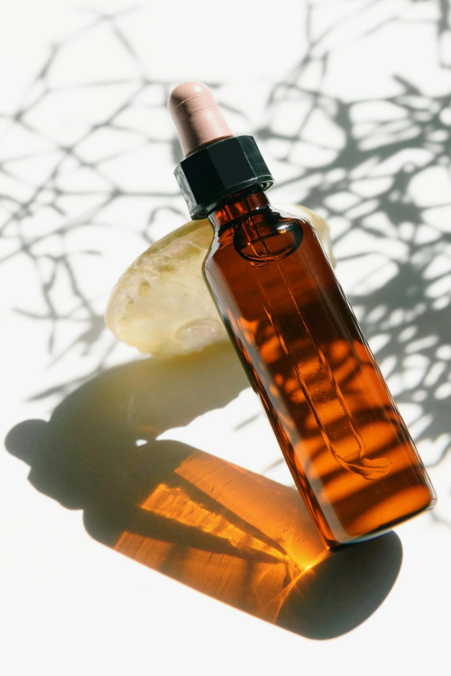 a bottle of essential oil next to a piece of bread, by Jessie Algie, with lemon skin texture, backlit, hair, thumbnail