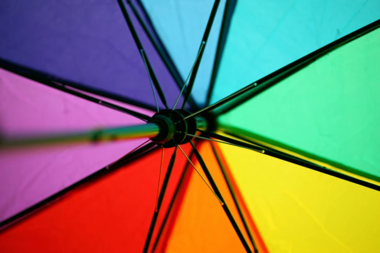 a close up of a rainbow colored umbrella, an album cover, pexels, deep colour, full colour, sunny light, full-color