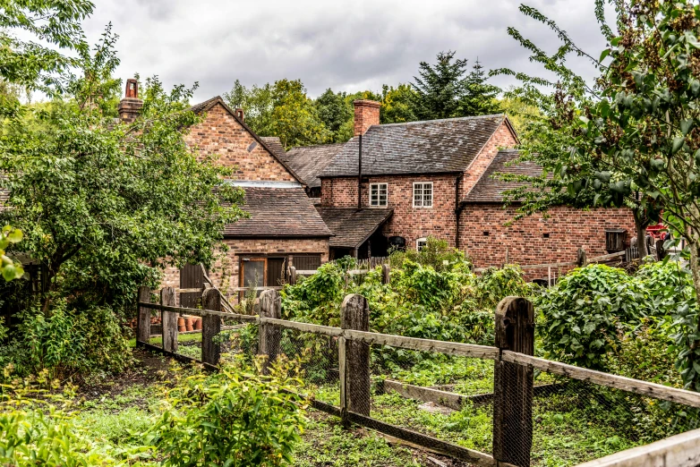 an old brick house surrounded by trees and bushes, inspired by Lewis Henry Meakin, pexels contest winner, farmland, wooden houses, coventry city centre, an idyllic vineyard