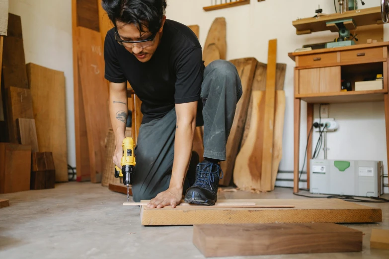 a man is working on a piece of wood, pexels contest winner, nanae kawahara, full body image, thumbnail, 1 2 9 7