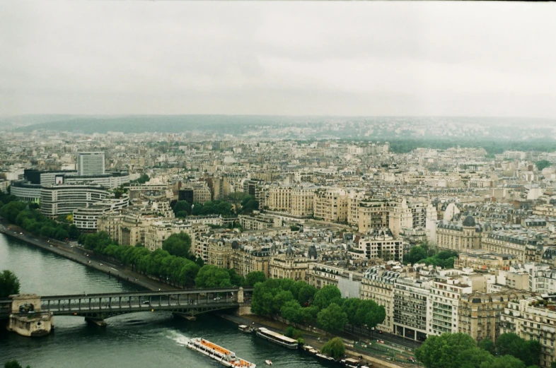 the view of paris from the top of the eiffel tower, inspired by Thomas Struth, pexels contest winner, grey skies, photo of green river, 2000s photo