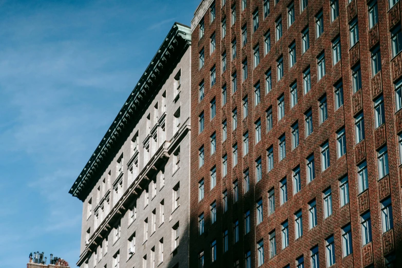 a clock that is on the side of a building, a photo, inspired by Donald Judd, unsplash, modernism, brown, montreal, ignant, clear blue skies