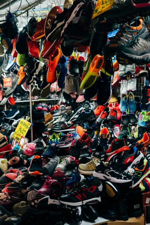 a market filled with lots of different types of shoes, by Daniel Lieske, trending on unsplash, in hong kong, scrapyard, panoramic shot, sport clothing