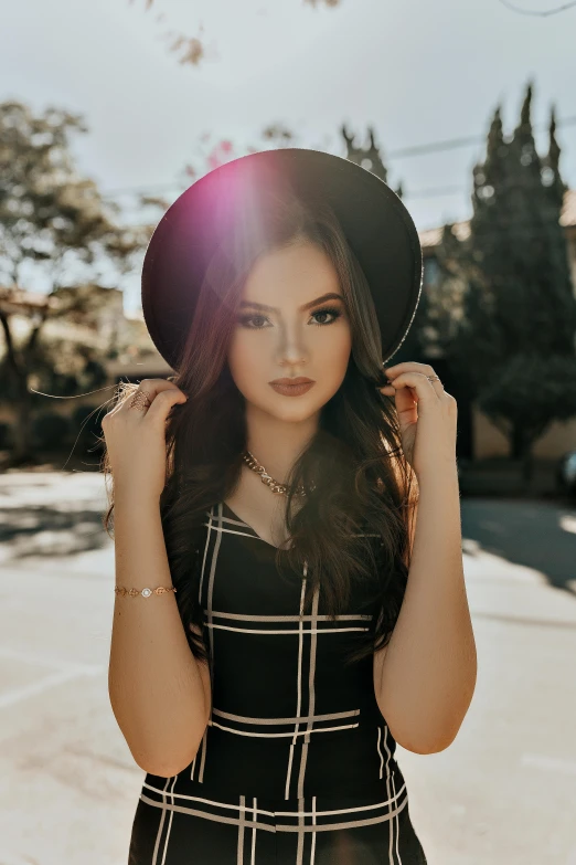 a woman in a black and white dress and hat, trending on pexels, teenage girl, square, bright and sunny, wearing a dark dress