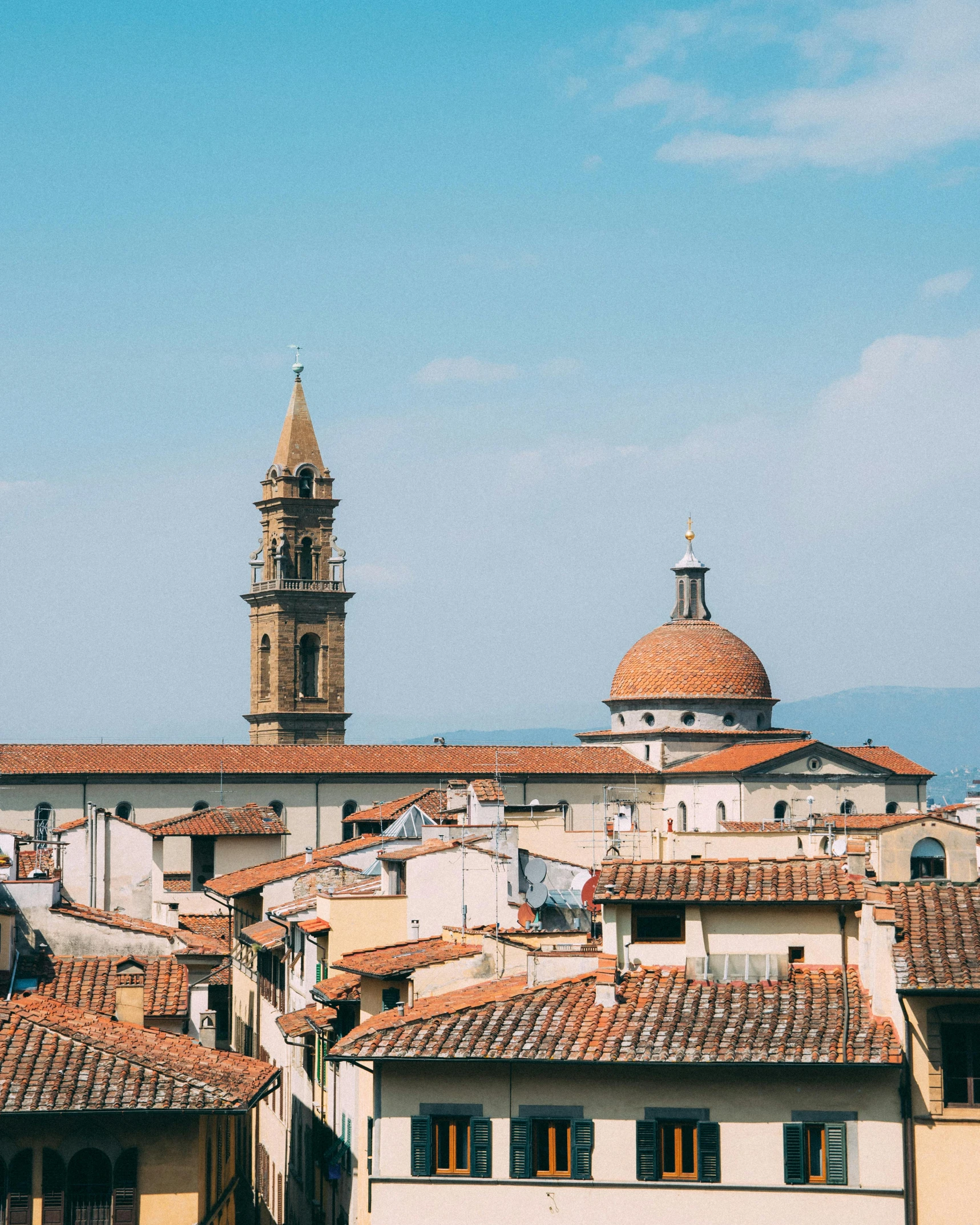 a group of buildings with a clock tower in the background, inspired by Michelangelo Buonarotti, pexels contest winner, renaissance, orange roof, bargello, distant photo, trending on vsco