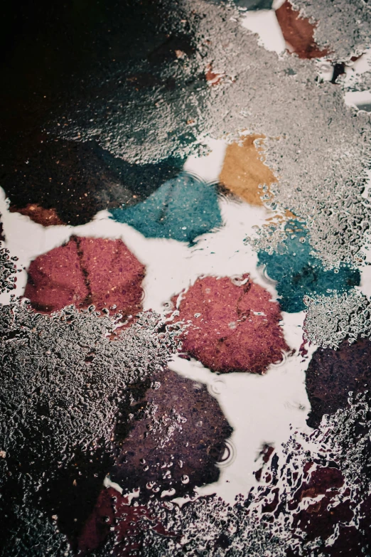 a cake sitting on top of a table covered in powdered sugar, an album cover, inspired by Elsa Bleda, trending on unsplash, lyrical abstraction, umbrellas, wet asphalt, kaleidoscopic colors, high angle close up shot