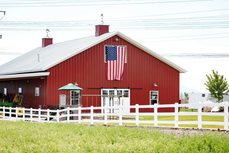 a red barn with an american flag on it, renaissance, conde nast traveler photo, of augean stables, profile image, crimson fork