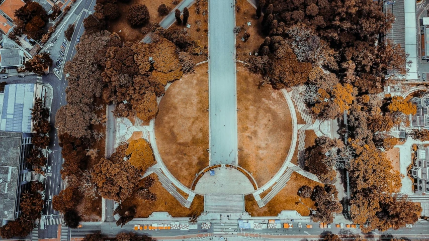 an aerial view of a monument surrounded by trees, by Alejandro Obregón, pexels contest winner, art nouveau, thumbnail, gigantic landing pad, brown, on a great neoclassical square