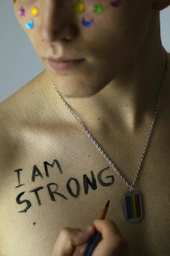 a man with the words i am strong painted on his chest, flickr, lgbt, male teenager, filmstill, ap news photograph