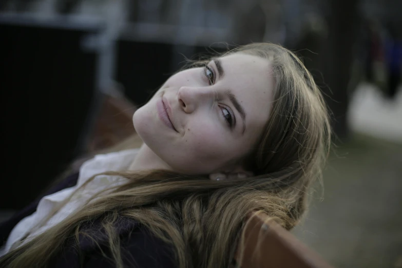 a beautiful young woman sitting on top of a wooden bench, a portrait, by Niko Henrichon, pexels contest winner, happening, brit marling style 3/4, portrait of happy a young woman, head shot, color photograph portrait 4k