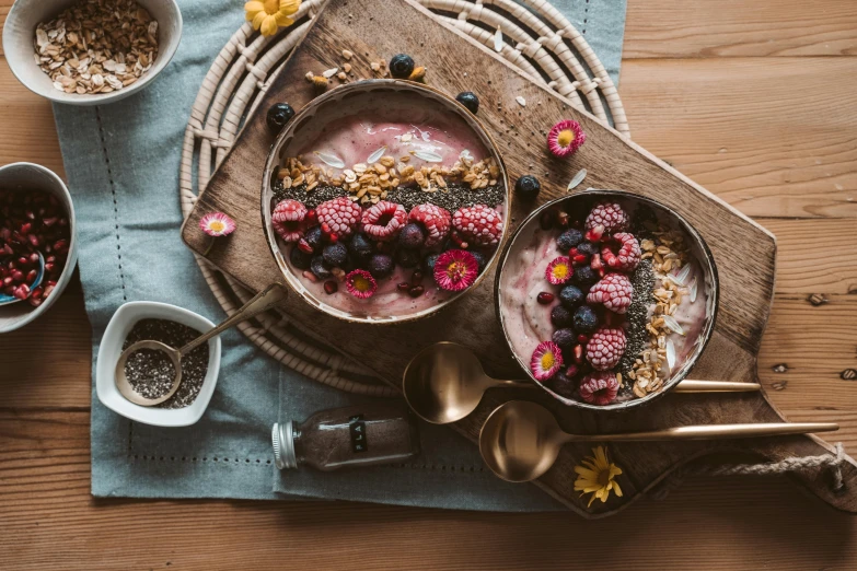 a bowl of yogurt topped with berries and granola, a still life, by Adam Marczyński, trending on pexels, hurufiyya, on a wooden tray, pink, background image, its bowl overflowing with plants