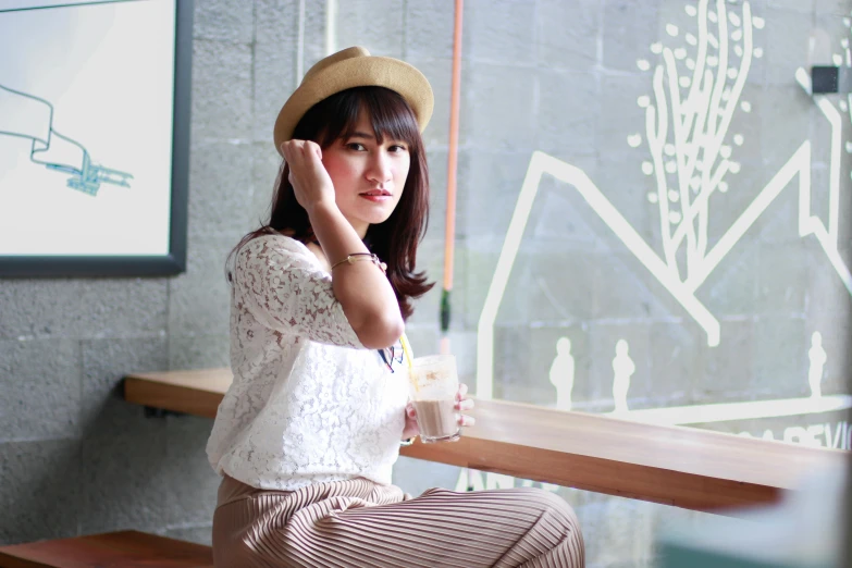 a woman sitting at a table talking on a cell phone, inspired by Ni Yuanlu, unsplash, sumatraism, caracter with brown hat, casual pose, sakimichan hdri, white hue