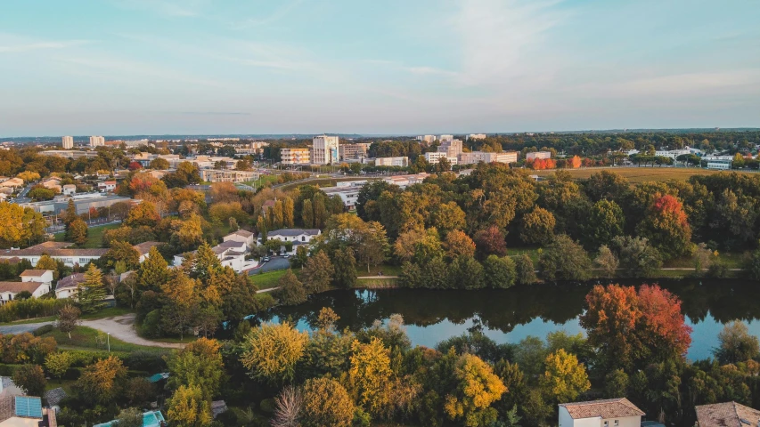 an aerial view of a city surrounded by trees, inspired by Washington Allston, pexels contest winner, northern france, lake foreground, from wheaton illinois, ultrawide angle cinematic view