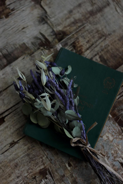 a bunch of flowers sitting on top of a wooden table, a picture, unsplash, romanticism, ((purple)), passport, sage green, made of dried flowers