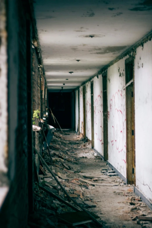 a long hallway with graffiti on the walls, unsplash, wrecked buildings, spooky photo, barracks, 2000s photo