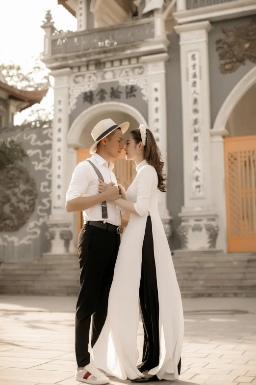a man and a woman standing in front of a building, inspired by Cui Bai, happening, vietnamese temple scene, kissing together cutely, ( ( theatrical ) ), 15081959 21121991 01012000 4k