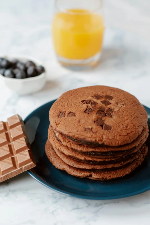 a stack of chocolate cookies sitting on top of a blue plate, a still life, trending on reddit, milk and mocha style, pancake flat head, high quality product image”, thumbnail