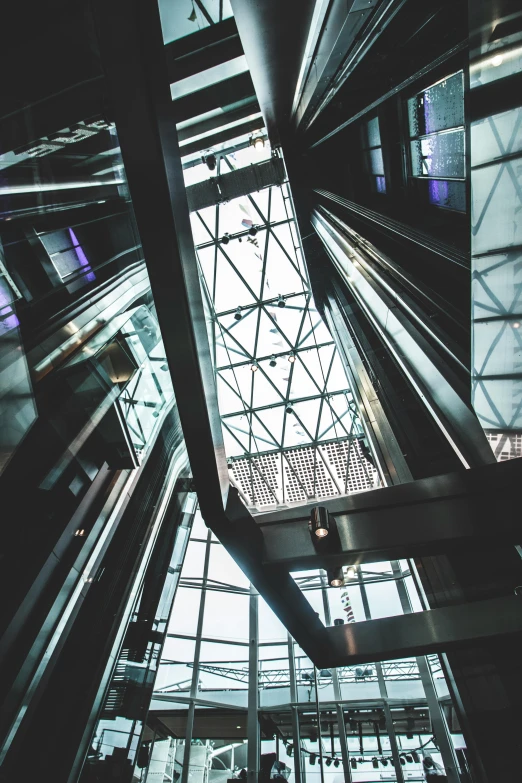 a very tall building with a lot of windows, unsplash, modernism, in an elevator, escalators, dark cables hanging from ceiling, parallax »