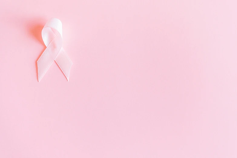 a white ribbon on a pink background, trending on pexels, tumors, background image, instagram post, ad image